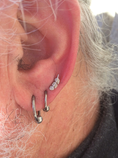 Triple Earlobe Piercing With Bead Rings And Feather Stud