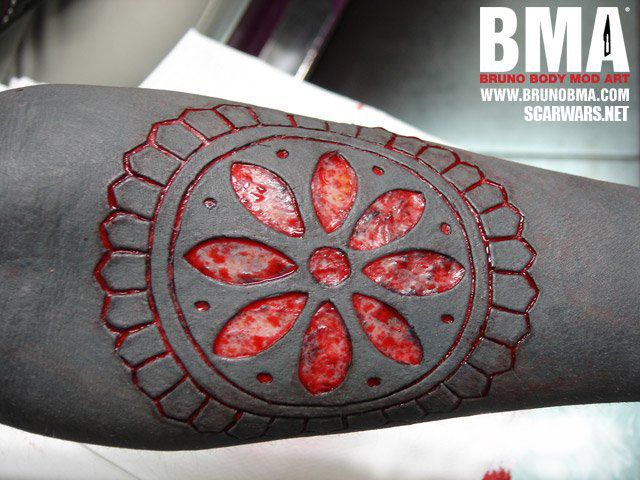 Wonderful Round Symbol Scarification Tattoo On Forearm