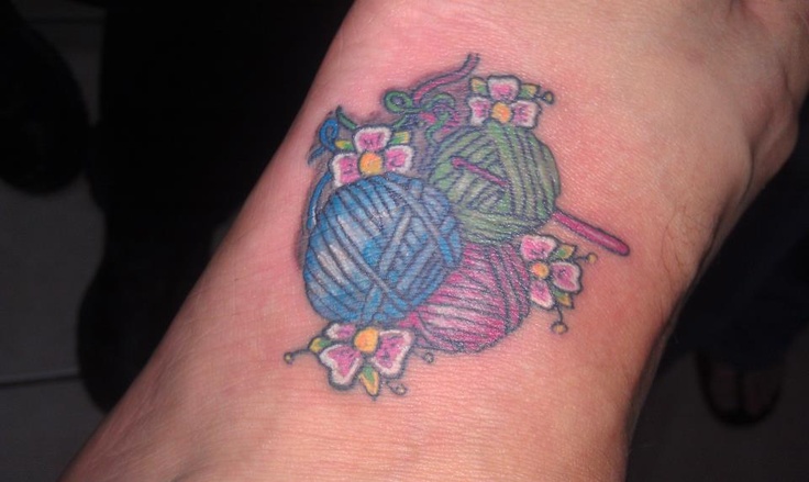 Yarn Balls With Flowers And Crochet Hook Tattoo On Wrist