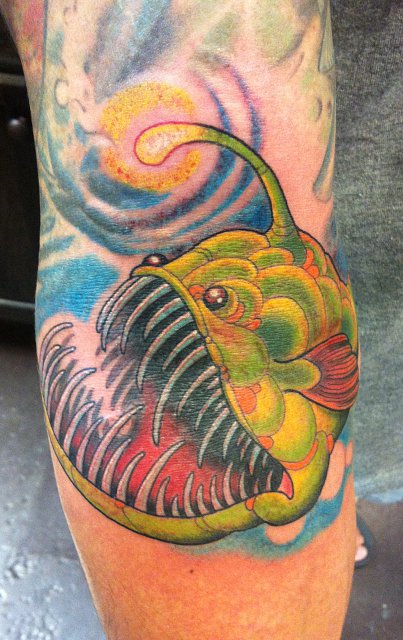 Attractive Green Angler Fish Tattoo On Arm