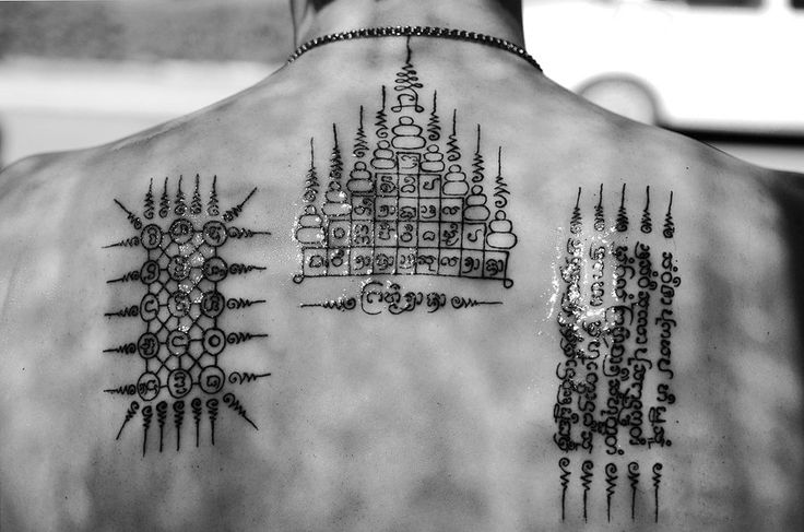 Awesome Thai Religious Symbols Tattoo On Upper Back