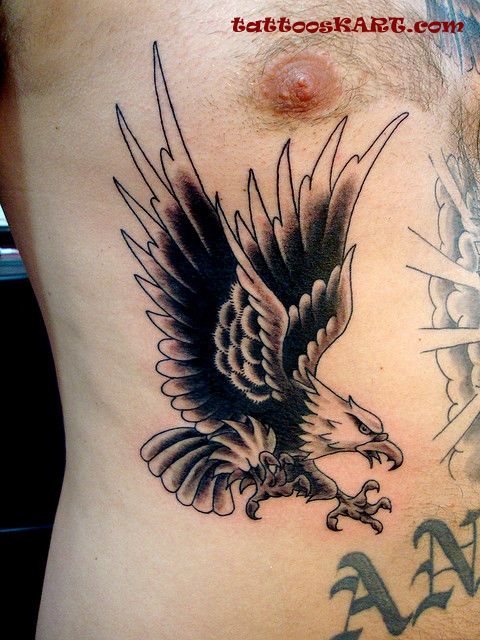 Black And Grey Flying Eagle Old School Tattoo On Side Rib