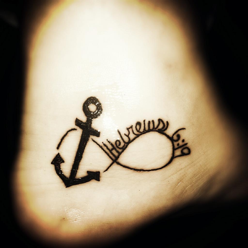 Black Ink Anchor Infinity Symbol Tattoo On Heel