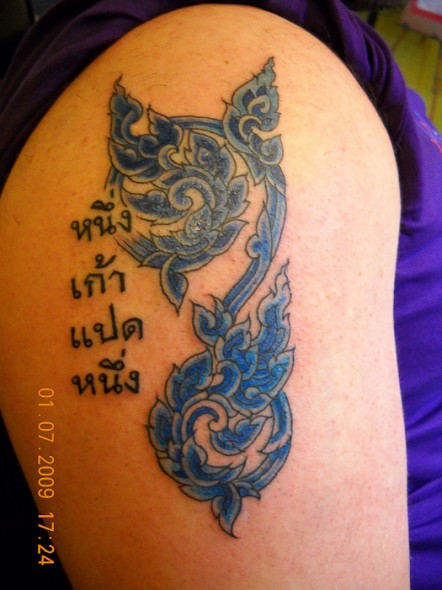 Blue Thai Plant Tattoo On Left Shoulder