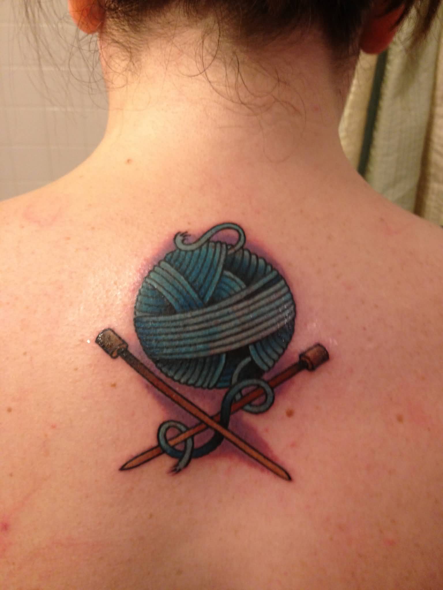 Blue Yarn With Knitting Needles Tattoo On Upper Back For Girls