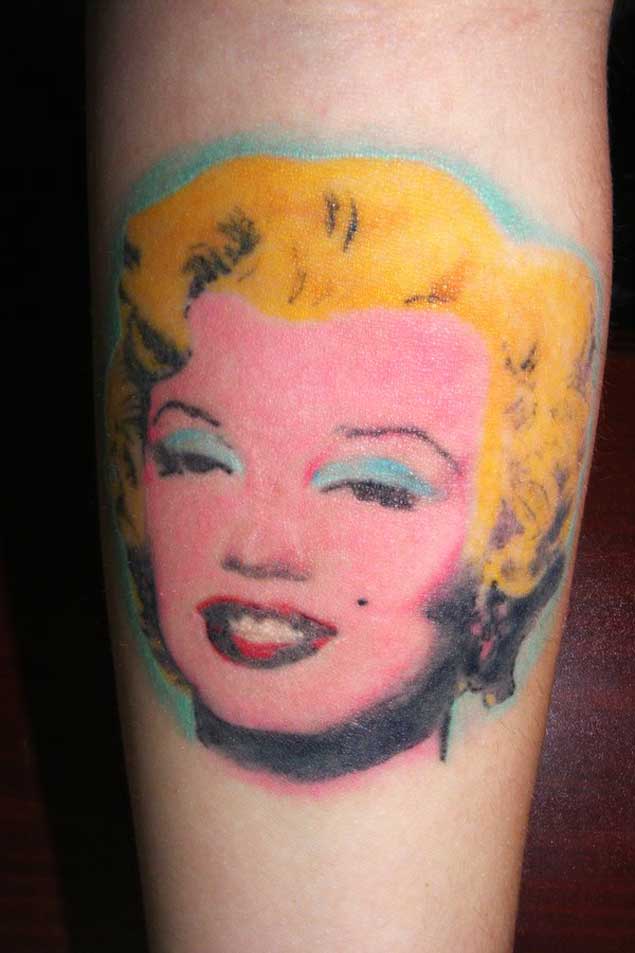 Colorful Marilyn Monroe Face Tattoo On Arm