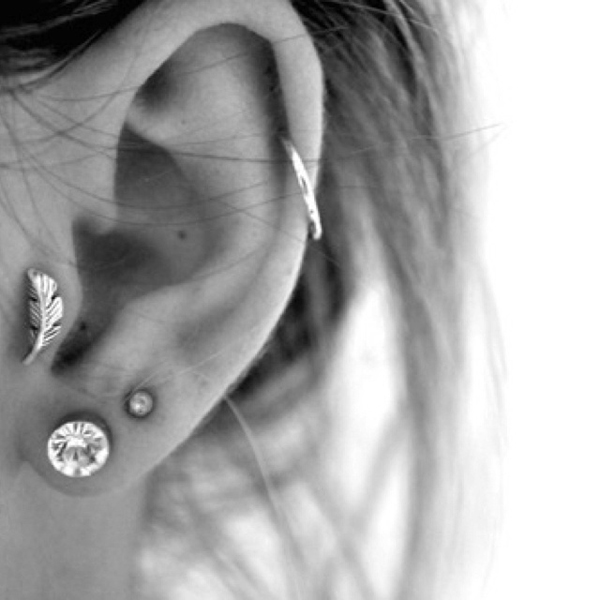 Double Lobes And Tragus Piercing With Feather Stud