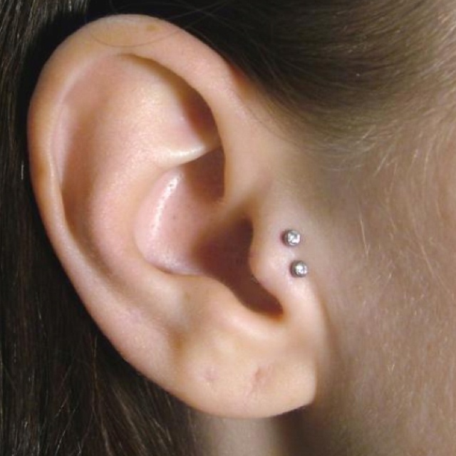 Double Tragus Piercing On Girl Right Ear
