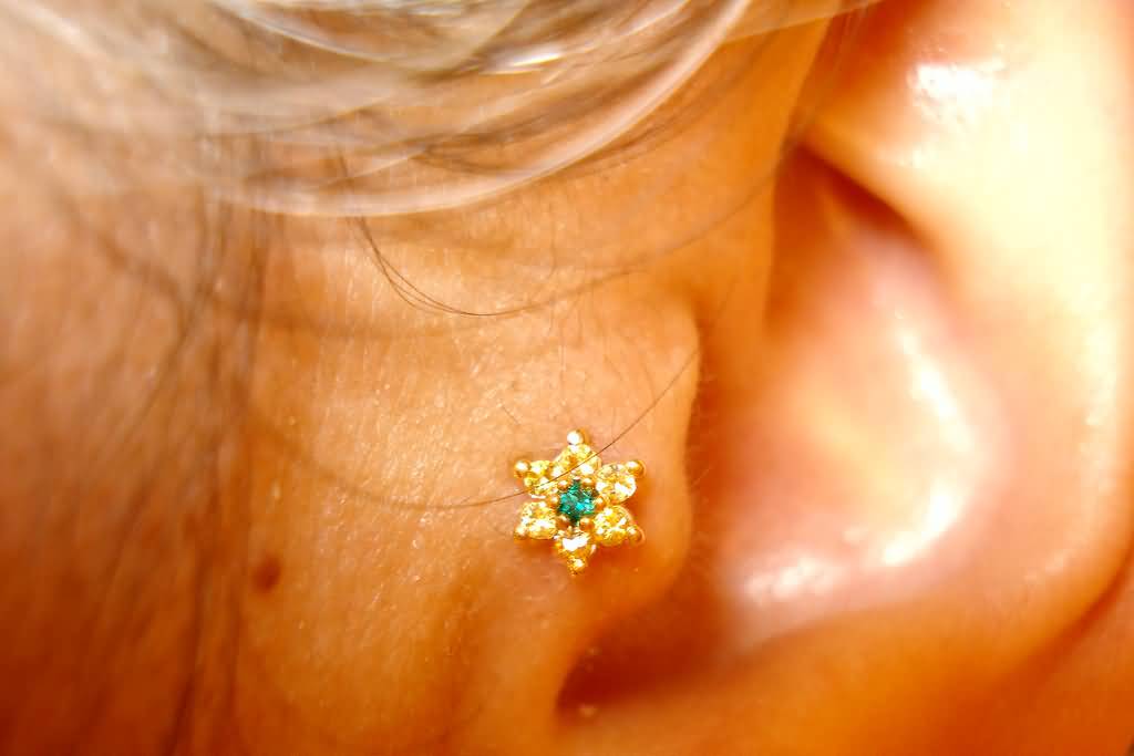 Flower Stud Tragus Piercing Closeup Image