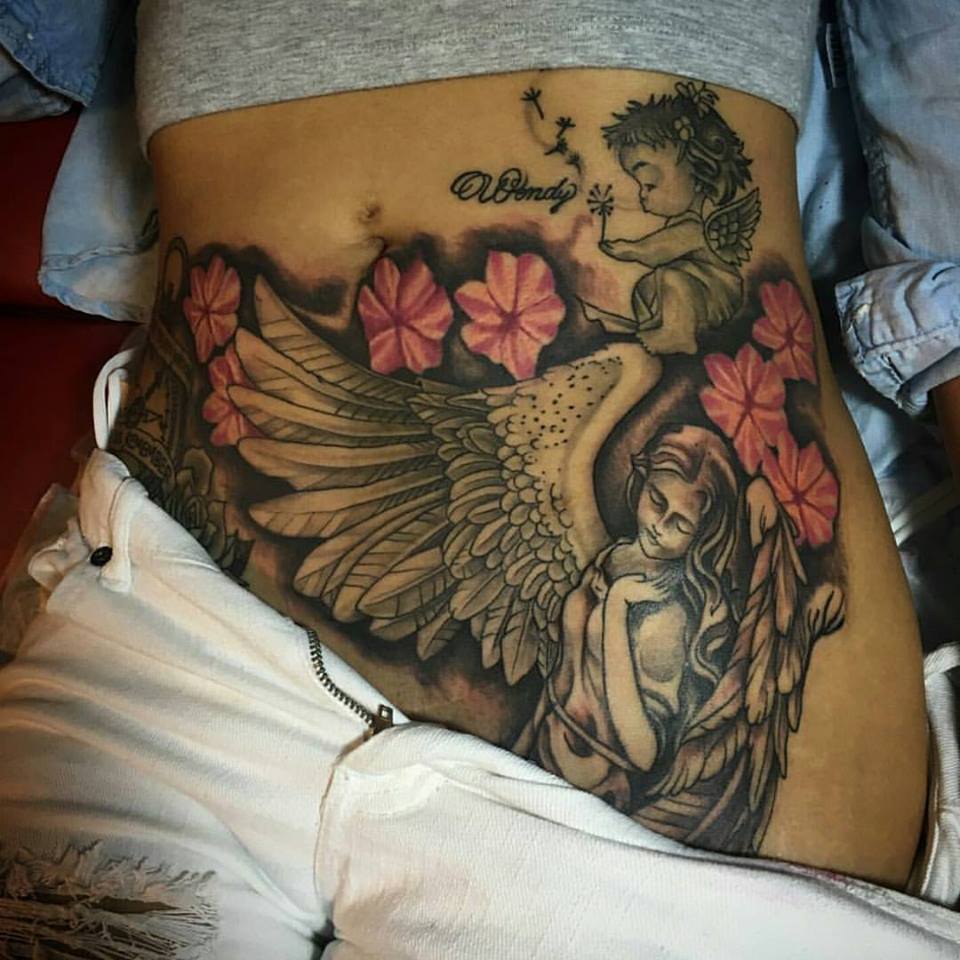 Flowers And Angel Tattoo On Hip by Randy Inks