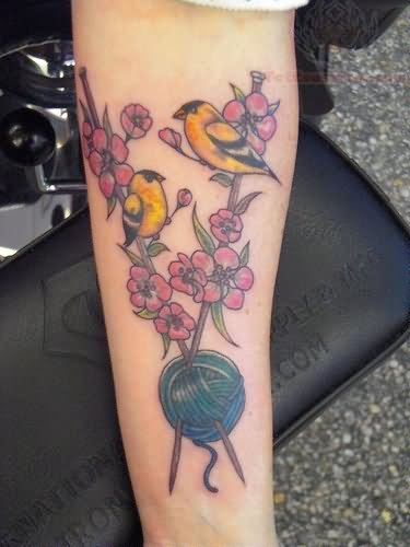 Flowers Sparrows And Knitting Tattoo On Forearm