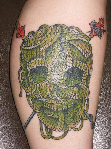Green Knitted Skull With Needles Tattoo