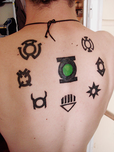 Green Lantern And Other Symbols Tattoo On Upper Back