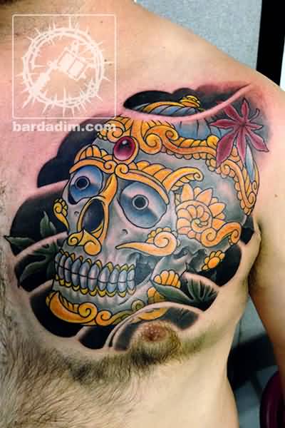 Grey And Yellow Tibetan Skull Tattoo On Chest For Men