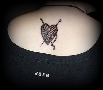 Grey Heart Yarn With Knitting Needles Tattoo On Upper Back For Girls