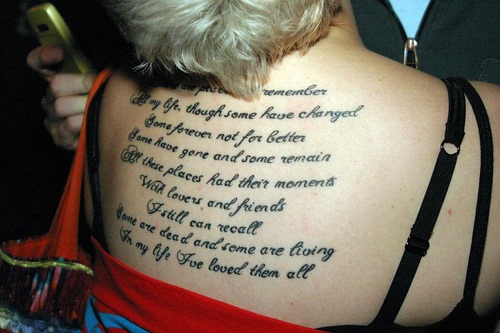 Lovely Poem Tattoo On Upper Back For Girls