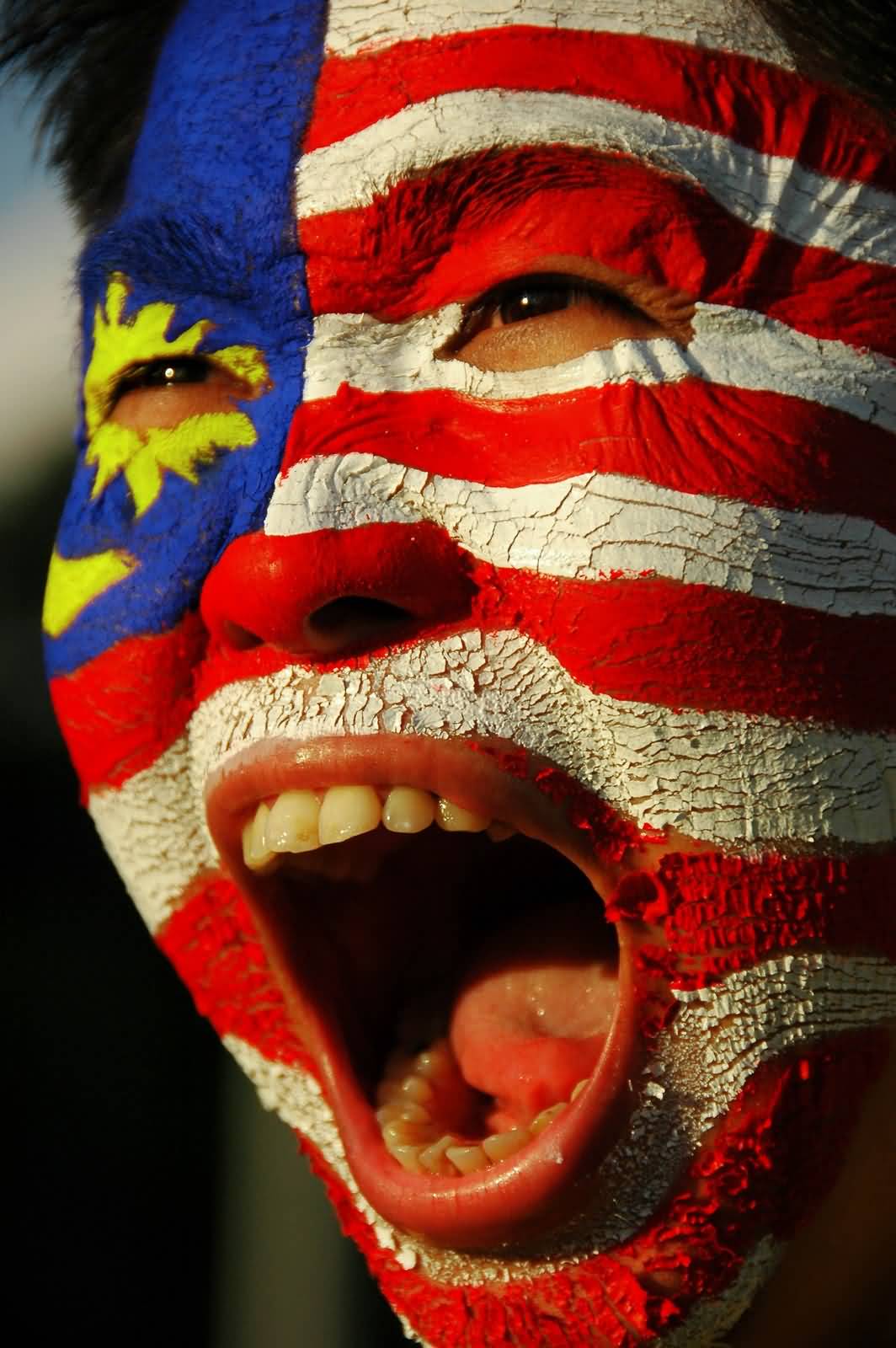 Man With Malaysian Flag Paint On Face During Malaysia Day Celebration
