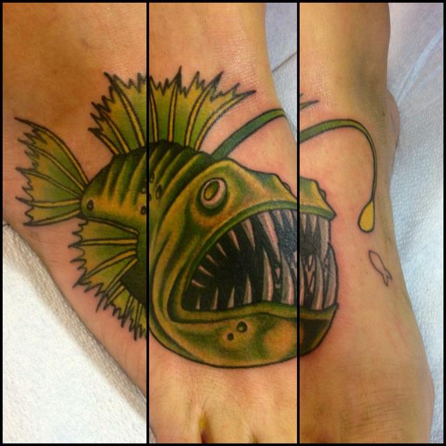 Nice Green Angler Fish Tattoo On Foot