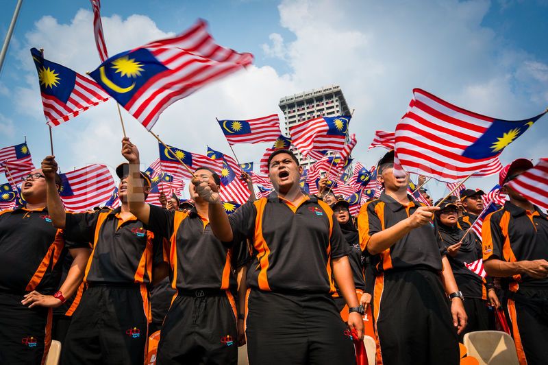 People Of Malaysia With Flags Celebrating Malaysia Day