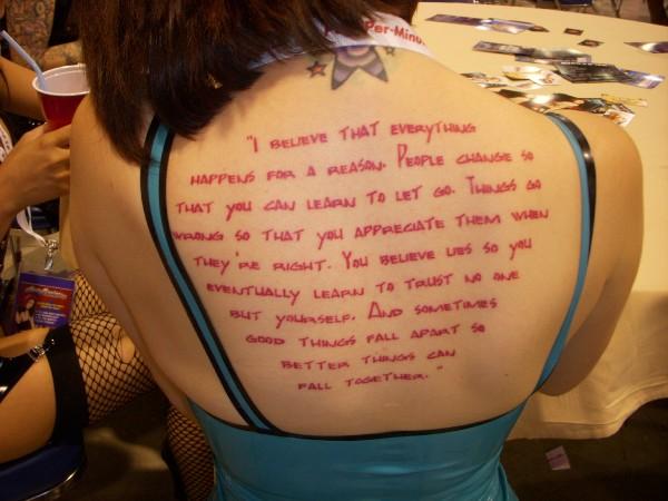 Red Marilyn Monroe Quote Tattoo On Upper Back