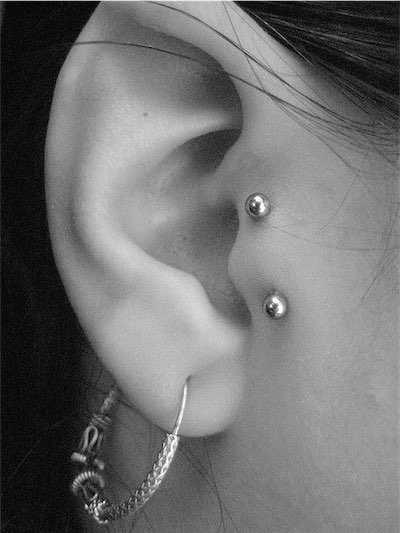 Right Ear Lobe And Surface Tragus Piercing