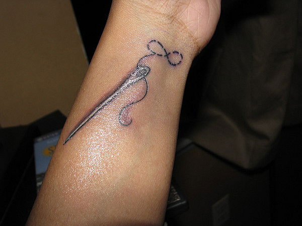 Sewing Needle Infinity Symbol Tattoo On Wrist