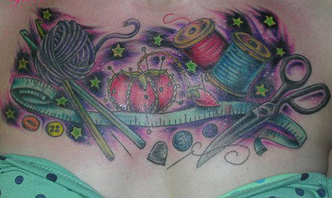 Spool And Knitting Tattoo On Chest For Girls