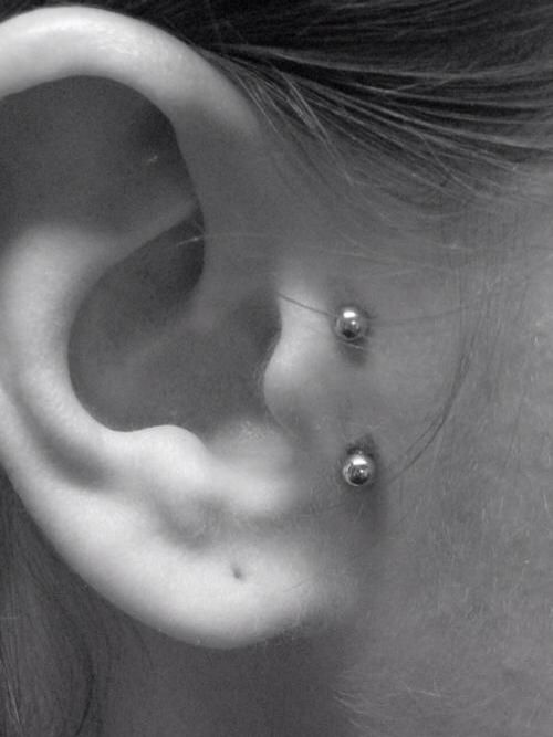 Surface Tragus Piercing On Right Ear With Silver Barbell
