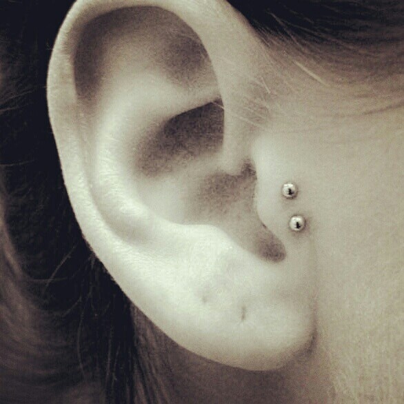 Surface Tragus Piercing With Silver Studs
