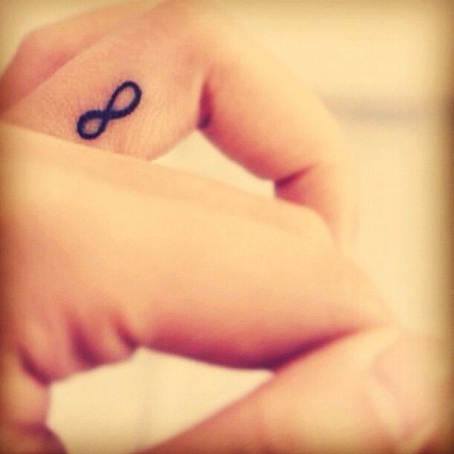 Tiny Infinity Symbol Tattoo On Finger