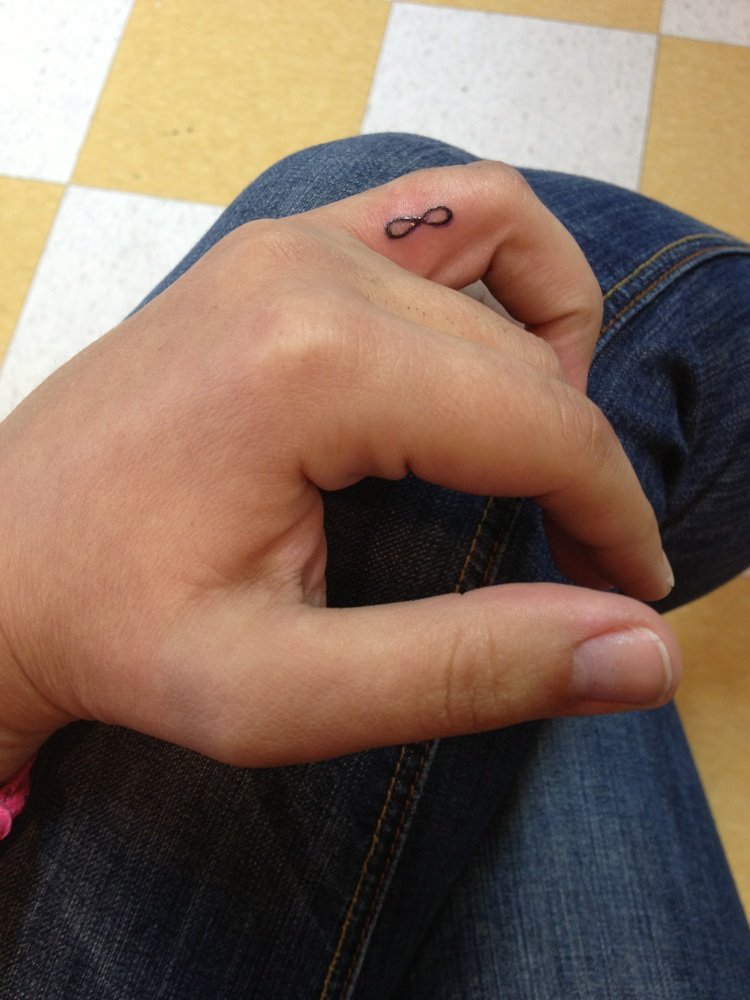 Tiny Infinity Tattoo On Finger