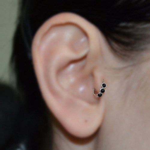 Tragus Piercing With Black Bead Rings
