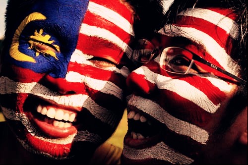 Two Boys Painted Malaysian Flag On Their Face During Malaysia Day Celebration