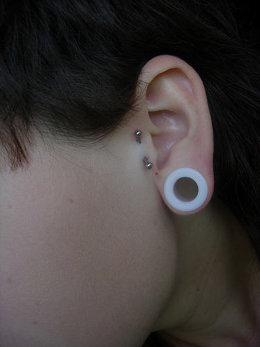 White Gauge Lobe Stretching And Tragus Piercing With Silver Barbell