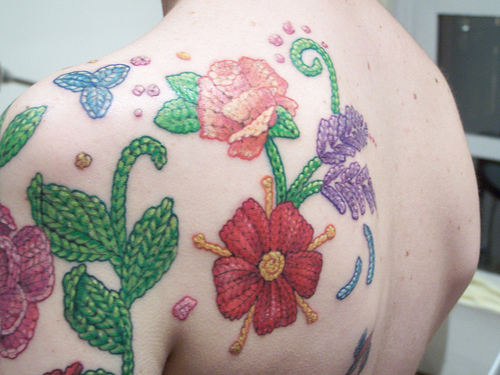 Wonderful Knitted Flowers Tattoo On Left Shoulder For Girls