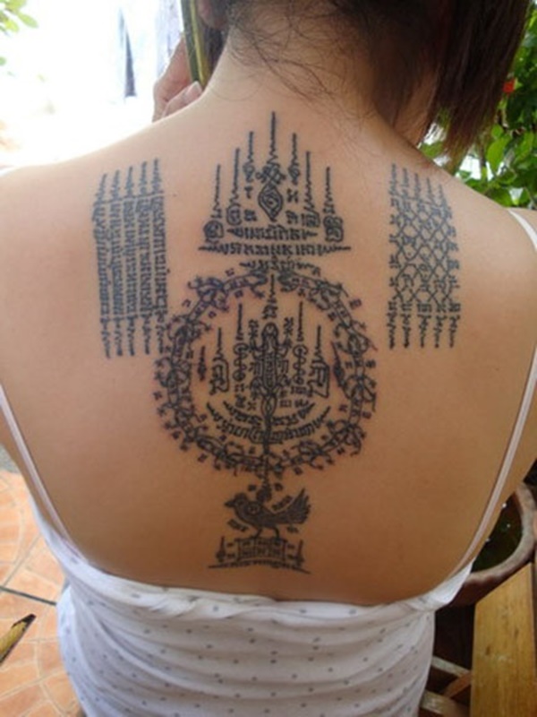 Wonderful Thai Symbols Tattoo On Upper Back For Girls
