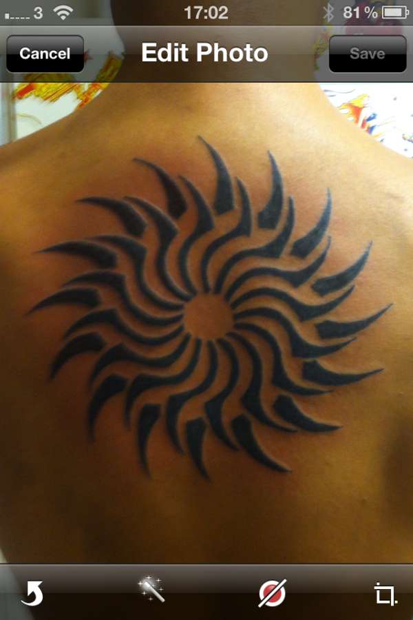 Awesome Tribal Spiral Sun Tattoo On Upper Back
