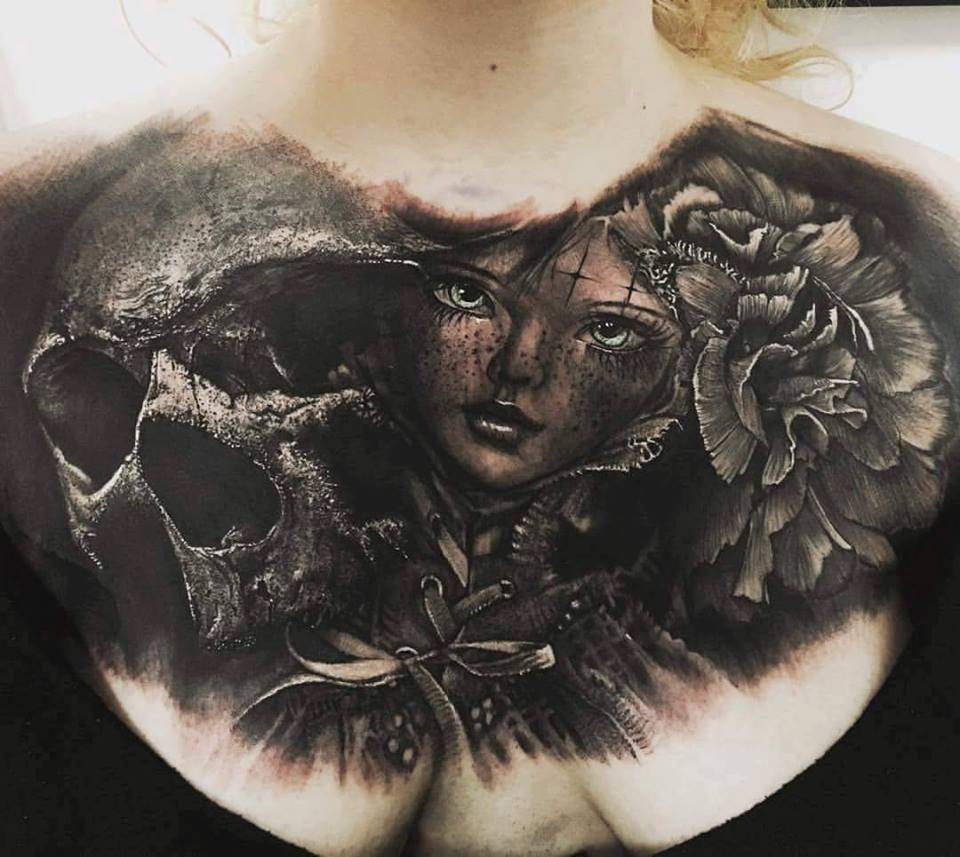Baby girl face and skull tattoo on chest by Sandry Riffard