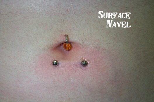 Belly Piercing With Bead Ring And Surface Navel Piercing With Barbell