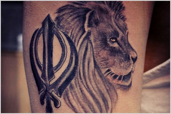 Black And Grey Khanda With Lion Tattoo