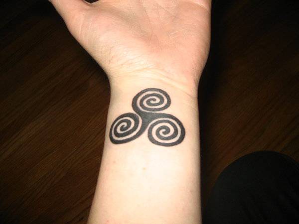 Black Triple Spiral Tattoo On Wrist