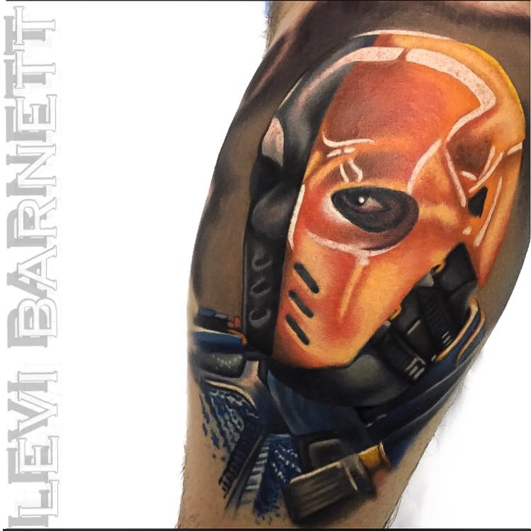 Black and orange gas mask tattoo on arm by Levi Barnett