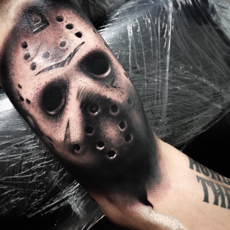 Black mask tattoo on arm by Levi Barnett 2