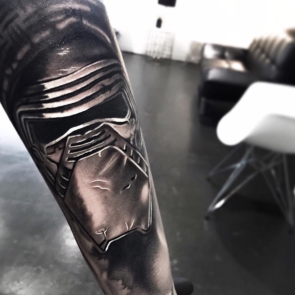 Black mask tattoo on arm by Levi Barnett