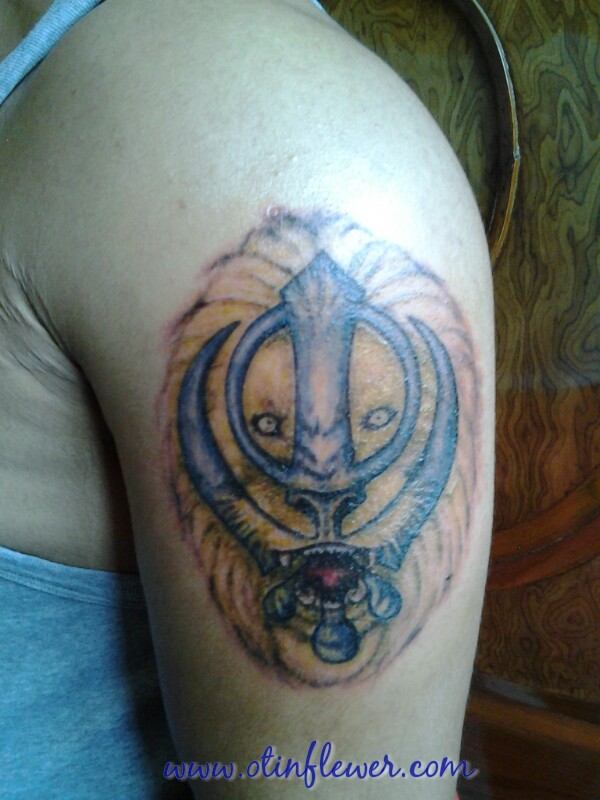 Blue Khanda On Lion Face Tattoo On Left Half Sleeve