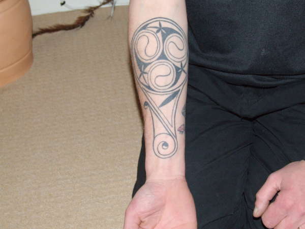 Celtic Spiral Bottle Tattoo On Forearm