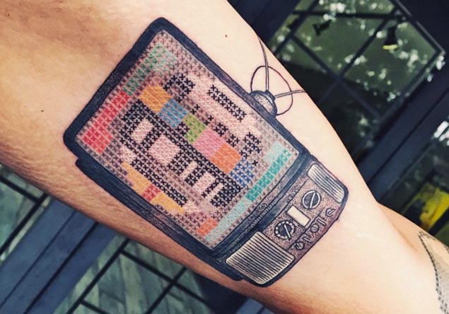 Cool Television Tattoo On Biceps
