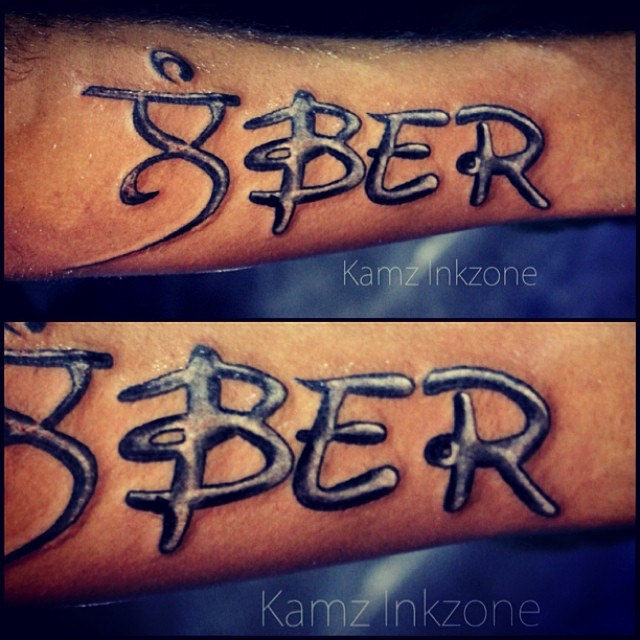 Creative Lamber In English Punjabi Font Tattoo On Arm