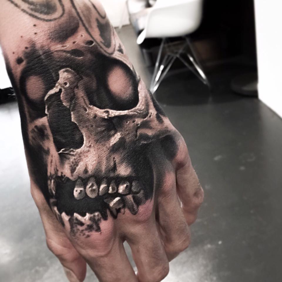 Dangerous skull tattoo on hand