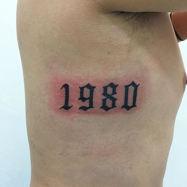 Different Color Year Number Tattoo On Side Rib For Men